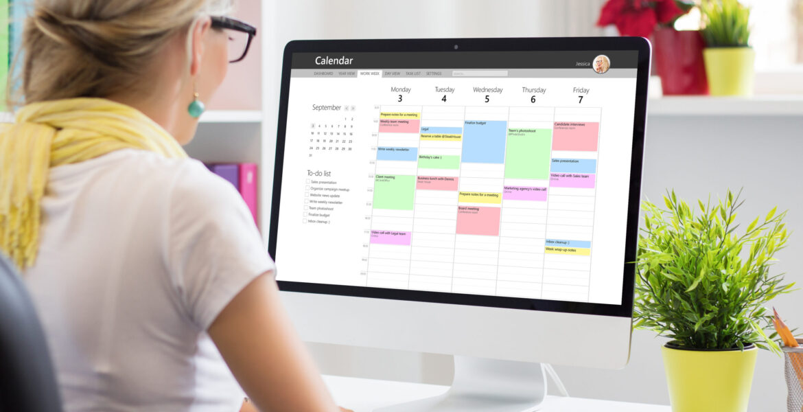 Woman,Using,Calendar,App,On,Computer,In,Office